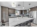 Updated kitchen with large marble island, dark cabinets, and stainless steel appliances at 9585 Teton Diablo Ave, Las Vegas, NV 89117