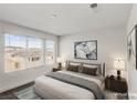Bright bedroom featuring large windows and a plush queen-sized bed at 9886 Alpine Style Dr, Las Vegas, NV 89166