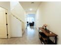 Inviting entryway with tile flooring, staircase, and view into the living room at 10021 Locking Biner Ave, Las Vegas, NV 89166
