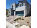 Contemporary home with clean lines, desert landscaping, and a two-car garage at 10021 Locking Biner Ave, Las Vegas, NV 89166