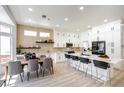 Spacious kitchen with an open floor plan, dining area, long island with seating, and modern, white cabinets at 10025 Netherton Dr, Las Vegas, NV 89134