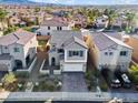 View of the home in a desirable neighborhood, showcasing its well-maintained landscaping and curb appeal at 1556 Olivia Pkwy, Henderson, NV 89011