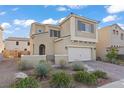 Charming two-story home featuring a two-car garage, desert landscaping, and elegant architectural details at 1556 Olivia Pkwy, Henderson, NV 89011