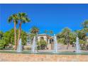 A house in a desert community is beautifully landscaped with palm trees and a fountain at 2050 W Warm Springs Rd # 4322, Henderson, NV 89014