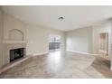 Spacious living room featuring a cozy fireplace and sliding glass doors at 2050 W Warm Springs Rd # 4322, Henderson, NV 89014