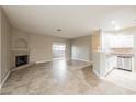 Open-concept living room features tile flooring, a fireplace, sliding glass doors to the patio, and adjoins the kitchen at 2050 W Warm Springs Rd # 4322, Henderson, NV 89014