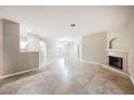 Open-plan living room showcasing the fireplace and connecting rooms at 2050 W Warm Springs Rd # 4322, Henderson, NV 89014