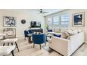 Open-concept living room featuring large windows, a sectional sofa, and modern furnishings at 2417 Fasano St, Henderson, NV 89044