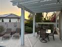 Inviting covered patio with outdoor seating, a block wall for privacy, and lush greenery offering a serene outdoor experience at 2440 Ping Dr, Henderson, NV 89074