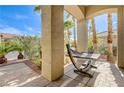 Relaxing outdoor patio featuring comfortable hammock, desert landscaping, and a serene atmosphere at 2440 Ping Dr, Henderson, NV 89074