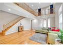 Bright living room with hardwood floors, a staircase, and a comfortable seating area at 2529 Flodden St, Henderson, NV 89044