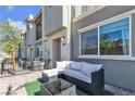 Relaxing front patio with comfortable outdoor furniture and a view of the surrounding neighborhood at 2598 Polar White Ave, North Las Vegas, NV 89086