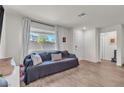Bright and airy living room featuring hardwood floors, a large window, and modern decor at 2598 Polar White Ave, North Las Vegas, NV 89086