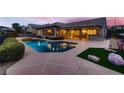 Private backyard with a sparkling pool, spa, and covered patio for outdoor entertaining at 2784 Cherrydale Falls Dr, Henderson, NV 89052