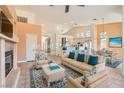 Staged living room features high ceilings, tile flooring, fireplace and cozy furniture at 2889 Anteres St, Las Vegas, NV 89117