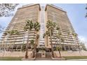 Impressive building exterior showcasing a high-rise tower with balconies and manicured palm trees at the entrance at 3111 Bel Air Dr # 23A, Las Vegas, NV 89109