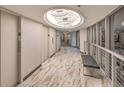 Elegant hallway with marble flooring, modern lighting fixtures, and comfortable bench seating at 3111 Bel Air Dr # 23A, Las Vegas, NV 89109