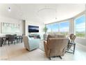 Open-concept living space with modern furnishings, including a large TV and floor to ceiling windows at 322 Karen Ave # 2201, Las Vegas, NV 89109