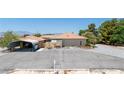 A single story home with orange tile roofing, desert landscaping, and covered parking at 3360 National Ave, Pahrump, NV 89048