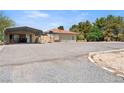 Front yard featuring desert landscaping, parking and a covered carport at 3360 National Ave, Pahrump, NV 89048