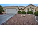 Beautiful single-story home with a two-car garage, manicured landscaping, and a welcoming entrance at 4005 Poppy Fields Dr, Las Vegas, NV 89129