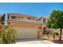 Charming two-story home featuring a tile roof, desert landscaping, and an attached two-car garage at 401 Sonoma Valley St, Las Vegas, NV 89144
