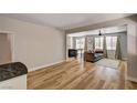 Open living room with wood floors and views into the yard at 401 Sonoma Valley St, Las Vegas, NV 89144