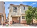 Charming two-story home boasts a balcony, well-maintained exterior, and beautiful desert landscaping, complete with cozy patio seating at 4037 Asante Cove St, Las Vegas, NV 89115