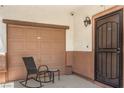 Cozy covered patio with comfortable seating near the garage and front door, offering a welcoming outdoor space at 4037 Asante Cove St, Las Vegas, NV 89115