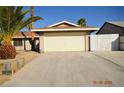 Inviting single-story home featuring a two-car garage and well-maintained desert landscape at 4354 Thorndale Pl, Las Vegas, NV 89103