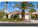 Charming single-story home with well-maintained lawn, desert landscaping, and a spacious two-car garage at 5028 Glenarden Dr, Las Vegas, NV 89130