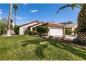 Beautifully landscaped front yard with lush green grass leading to a cozy single-story home at 5028 Glenarden Dr, Las Vegas, NV 89130