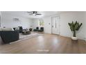 Staged living room with a front door entry, hardwood floors, and recessed lighting at 5069 Hallet Dr, Las Vegas, NV 89122
