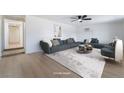 Bright, staged living room with neutral tones, recessed lighting, and hardwood flooring at 5069 Hallet Dr, Las Vegas, NV 89122