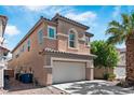Two-story home featuring a two car garage and desert landscaping at 5116 Iron Crossing Ave, Las Vegas, NV 89131