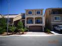 Inviting three-story home boasting a neutral stucco exterior, balcony, and an attached two-car garage at 5889 Thistle Meadow Ave, Las Vegas, NV 89139