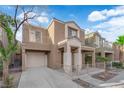 Charming two-story house featuring an attached garage and a quaint front patio at 6284 Anticline Ave, Las Vegas, NV 89139