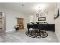 Elegant living room featuring gray tile floors, a grand piano, and stylish decor, creating a welcoming atmosphere at 6688 Martinsville Pl, Las Vegas, NV 89110