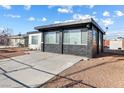 Single story home with a mix of white and black brick exterior and easy to maintain gravel landscaping at 704 Slayton Dr, Las Vegas, NV 89107