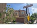 Exterior view of a two-story home with a private garage on a sunny day at 7704 Classy Cashmere Ct, Las Vegas, NV 89149