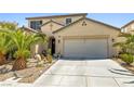 Inviting home exterior featuring a spacious two-car garage and desert landscaping at 7724 Somerhill Point Way, Las Vegas, NV 89139