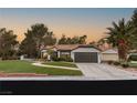 Beautiful single-story home with a two-car garage, lush lawn and desert landscaping at 9029 Rivers Edge Dr, Las Vegas, NV 89117