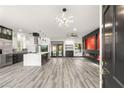Modern living room with sleek floors, a fireplace, and a stylish kitchen with stainless appliances at 9029 Rivers Edge Dr, Las Vegas, NV 89117