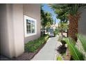 Side view of a home with lush greenery and palm trees enhancing its curb appeal at 912 Pro Players Dr, Las Vegas, NV 89134