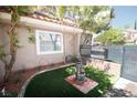 Beautifully landscaped front yard featuring a charming fountain and vibrant green lawn at 912 Pro Players Dr, Las Vegas, NV 89134