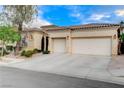 Beautiful single-story home with a spacious driveway, two-car garage, and classic architectural design at 9349 Olympia Falls Ave, Las Vegas, NV 89149