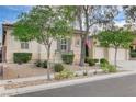 Inviting single-story home with mature trees, manicured landscaping, and neutral-toned exterior at 9349 Olympia Falls Ave, Las Vegas, NV 89149