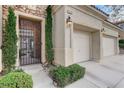 Close-up of the front entrance, showcasing a secure decorative gate and tidy landscaping at 9349 Olympia Falls Ave, Las Vegas, NV 89149