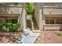 Exterior shot of building with stairs leading to upper units and well maintained landscaping at , Las Vegas, NV 89120