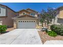 Charming two-story home featuring a two car garage, landscaped yard and a concrete driveway at 104 Big Cliff Ave, North Las Vegas, NV 89031